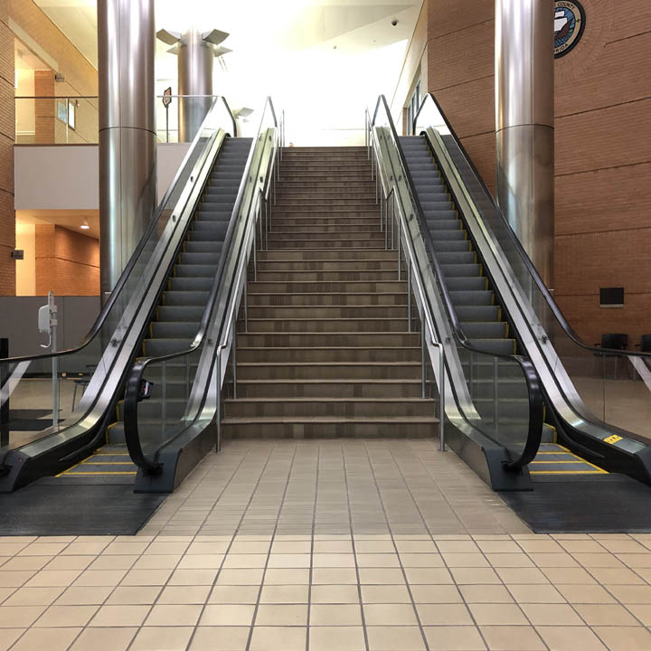 Grand entry of Manatee County Judicial Center (MCJC) with stairwell and escalators to the second floor