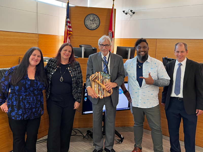 This is an image of a presentation screen in a large meeting that is displaying an award certificate for Judge Smith.