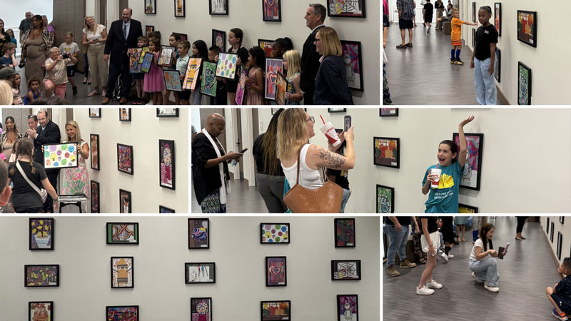 The images depict rows of children's artwork hanging on a wall; children holding framed artwork they made, standing in front of the reproductions that hang on the wall behind them, while adults in business suits look on; parents taking pictures of their children in front of their artwork hanging on the wall behind them.